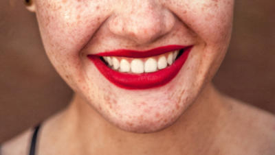 Upclose picture of woman smiling with red lipstick